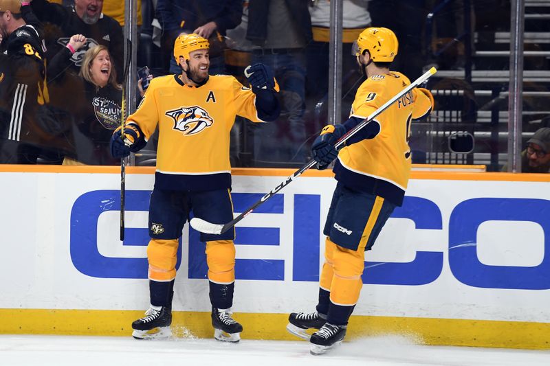 Apr 9, 2024; Nashville, Tennessee, USA; Nashville Predators center Ryan O'Reilly (90) celebrates with left wing Filip Forsberg (9) after a goal during the third period at Bridgestone Arena. Mandatory Credit: Christopher Hanewinckel-USA TODAY Sports