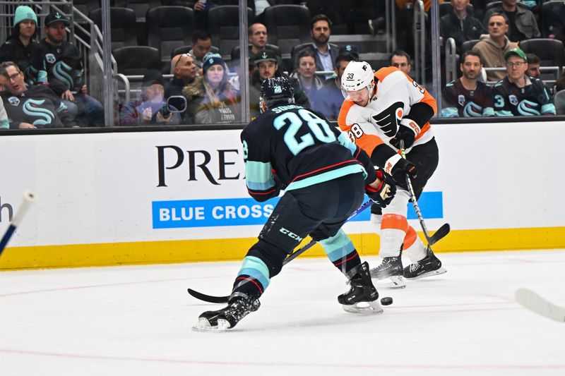 Feb 16, 2023; Seattle, Washington, USA; Philadelphia Flyers center Patrick Brown (38) passes the puck past Seattle Kraken defenseman Carson Soucy (28) during the second period at Climate Pledge Arena. Mandatory Credit: Steven Bisig-USA TODAY Sports