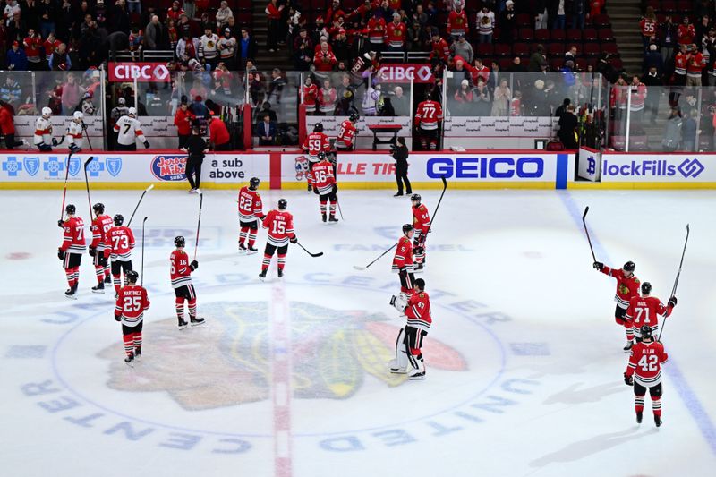 Nov 21, 2024; Chicago, Illinois, USA; The Chicago Blackhawks celebrate their win against the Florida Panthers after the game at the United Center. Mandatory Credit: Daniel Bartel-Imagn Images