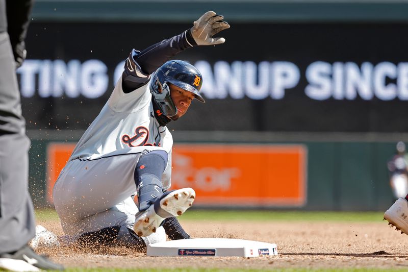 Apr 20, 2024; Minneapolis, Minnesota, USA; Detroit Tigers right fielder Wenceel Perez (46) slides into third base on an RBI triple against the Minnesota Twins in the sixth inning at Target Field. Mandatory Credit: Bruce Kluckhohn-USA TODAY Sports