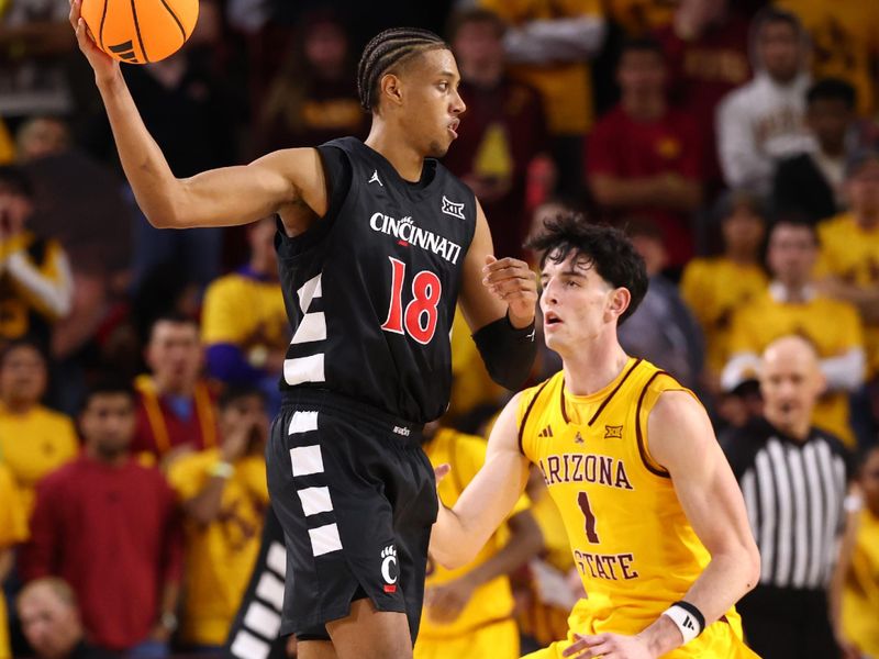 Jan 24, 2026; Tempe, Arizona, USA; Cincinnati Bearcats forward Baba Miller (18) moves the ball against Arizona State Sun Devils forward Santiago Trouet (1) in the second half at Desert Financial Arena. Mandatory Credit: Mark J. Rebilas-Imagn Images