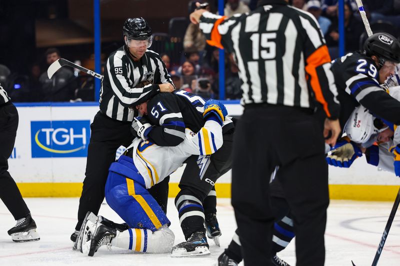 Feb 28, 2026; Tampa, Florida, USA; Tampa Bay Lightning defenseman Charle-Edouard D'Astous (51) and Buffalo Sabres forward Alex Tuch (89) get into a scuffle during the third period at Benchmark International Arena. Mandatory Credit: Morgan Tencza-Imagn Images 