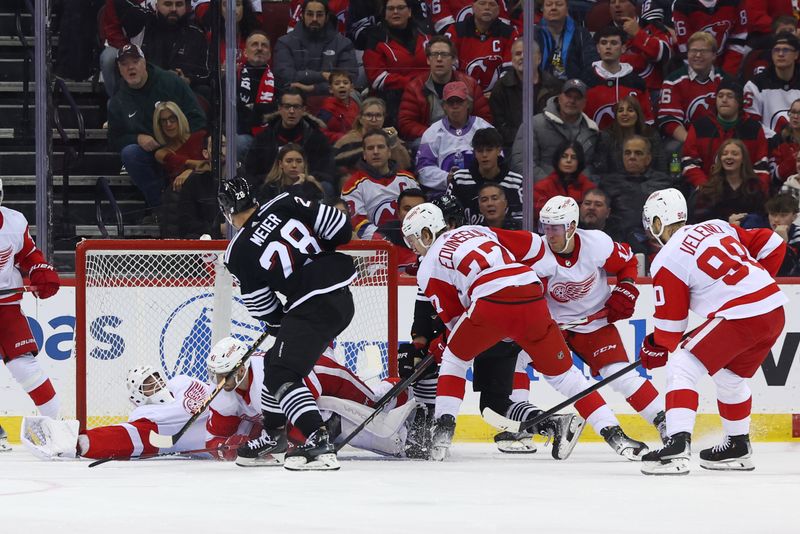 Dec 23, 2023; Newark, New Jersey, USA; New Jersey Devils right wing Timo Meier (28) scores a goal against the Detroit Red Wings during the first period at Prudential Center. Mandatory Credit: Ed Mulholland-USA TODAY Sports