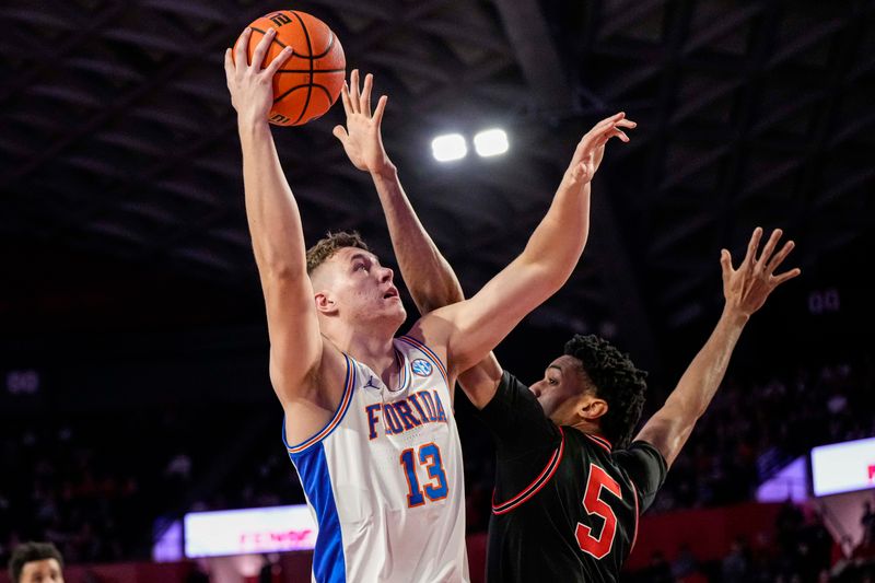 Feb 28, 2023; Athens, Georgia, USA; Florida Gators forward Aleks Szymczyk (13) shoots over Georgia Bulldogs center Frank Anselem (5) during the first half at Stegeman Coliseum. Mandatory Credit: Dale Zanine-USA TODAY Sports