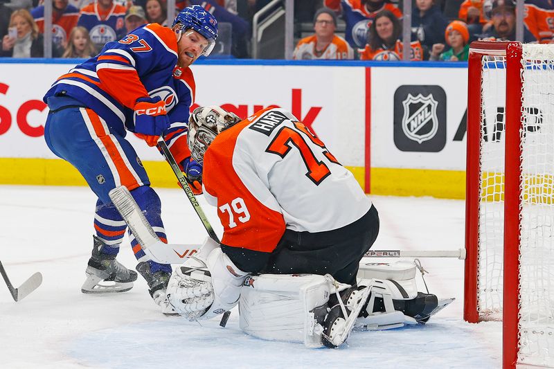 Jan 2, 2024; Edmonton, Alberta, CAN; Philadelphia Flyers goaltender Carter Hart (79) makes a save on Edmonton Oilers forward Warren Foegele (37) during the first period at Rogers Place. Mandatory Credit: Perry Nelson-USA TODAY Sports