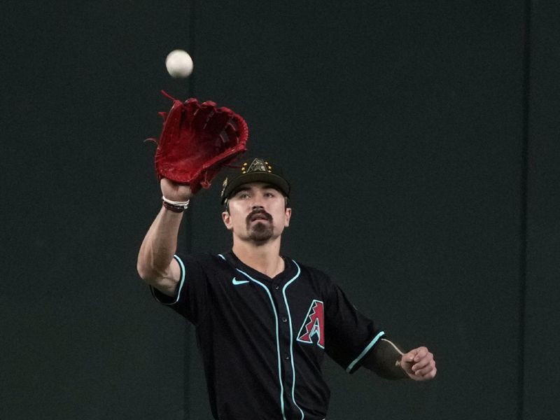 May 17, 2024; Phoenix, Arizona, USA; Arizona Diamondbacks outfielder Corbin Carroll (7) makes the running catch against the Detroit Tigers in the first inning at Chase Field. Mandatory Credit: Rick Scuteri-USA TODAY Sports