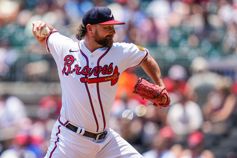 Jun 28, 2023; Cumberland, Georgia, USA; Atlanta Braves relief pitcher Kirby Yates (22) pitches against the Minnesota Twins during the sixth inning at Truist Park. Mandatory Credit: Dale Zanine-USA TODAY Sports