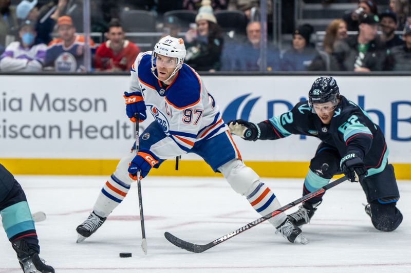 Oct 25, 2025; Seattle, Washington, USA; Edmonton Oilers forward Connor McDavid (97) skates against Seattle Kraken defenseman Brandon Montour (62) during the first period at Climate Pledge Arena. Mandatory Credit: Stephen Brashear-Imagn Images
