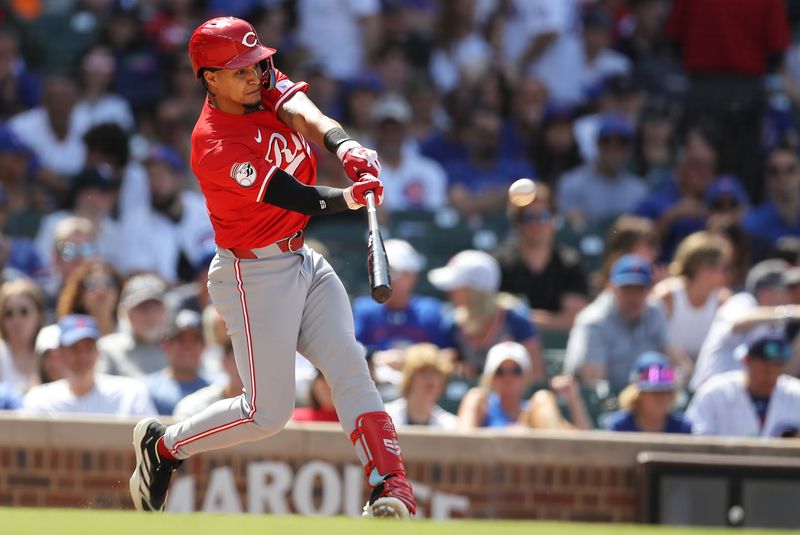 May 31, 2024; Chicago, Illinois, USA; Cincinnati Reds pinch hitter Santiago Espinal (4) hits a two-run home run during the seventh inning against the Cincinnati Reds at Wrigley Field. Mandatory Credit: Melissa Tamez-USA TODAY Sports