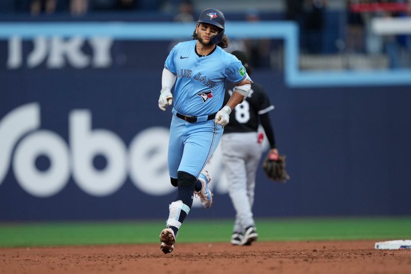 May 22, 2024; Toronto, Ontario, CAN; Toronto Blue Jays shortstop Bo Bichette (11) rounds the bases after hitting a two-run home run against the Chicago White Sox during the second inning at Rogers Centre. Mandatory Credit: John E. Sokolowski-USA TODAY Sports