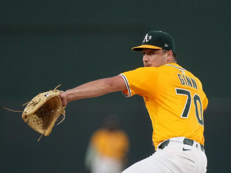 Sep 12, 2025; West Sacramento, California, USA; Athletics pitcher J.T. Ginn (70) prepares to deliver a pitch against the Cincinnati Reds in the first inning at Sutter Health Park. Mandatory Credit: Cary Edmondson-Imagn Images