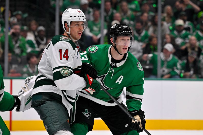 Oct 14, 2025; Dallas, Texas, USA; Minnesota Wild center Joel Eriksson Ek (14) and Dallas Stars defenseman Esa Lindell (23) battle for position during the third period at the American Airlines Center. Mandatory Credit: Jerome Miron-Imagn Images