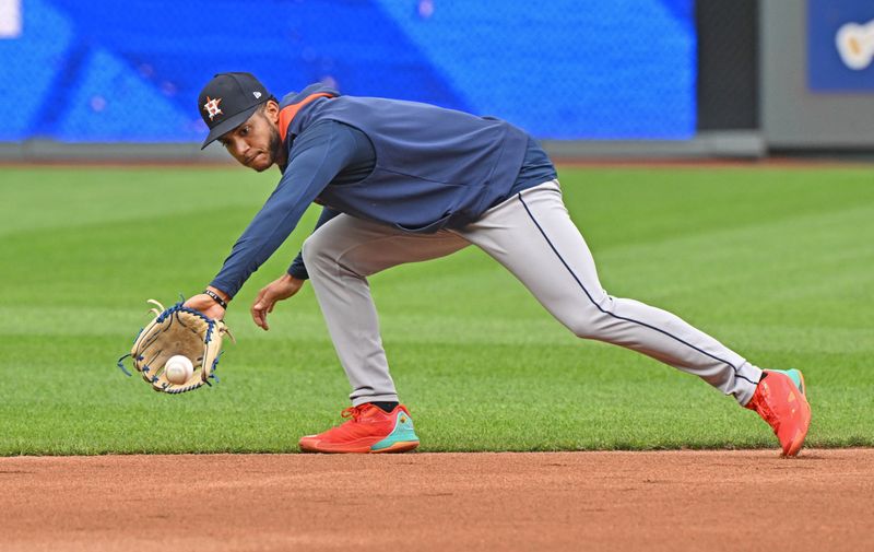 Apr 25, 2025; Kansas City, Missouri, USA;  Houston Astros shortstop Jeremy Pena (3) fields a ground ball during batting practice before a game against the Kansas City Royals at Kauffman Stadium. Mandatory Credit: Peter Aiken-Imagn Images