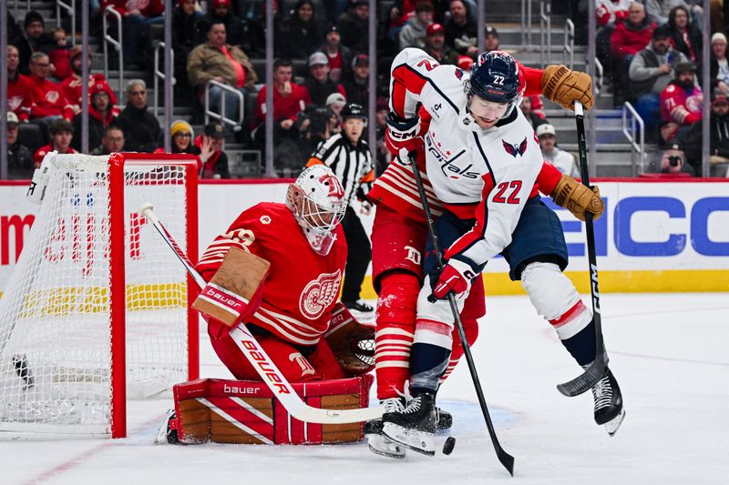 Dec 21, 2025; Detroit, Michigan, USA; Detroit Red Wings goaltender Cam Talbot (39) and defenseman Travis Hamonic (52) defend Washington Capitals right wing Brandon Duhaime (22) during the first period at Little Caesars Arena. Mandatory Credit: Tim Fuller-Imagn Images