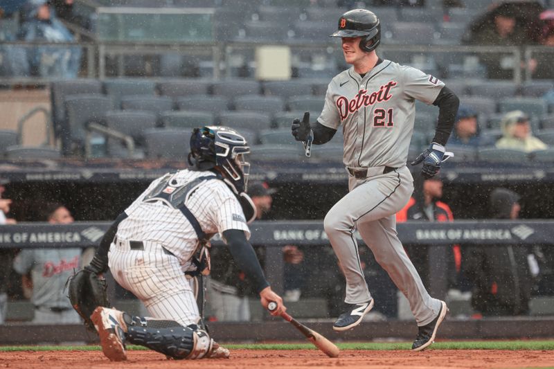 May 5, 2024; Bronx, New York, USA; Detroit Tigers designated hitter Mark Canha (21) scores a run in front of New York Yankees catcher Jose Trevino (39) during the seventh inning on a double by first baseman Spencer Torkelson (not pictured) at Yankee Stadium. Mandatory Credit: Vincent Carchietta-USA TODAY Sports