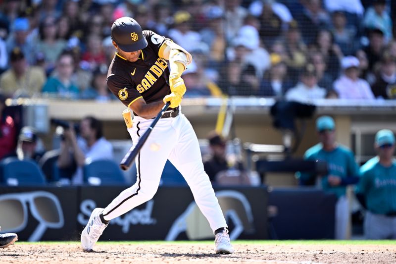 Mar 26, 2024; San Diego, California, USA; San Diego Padres left fielder Jose Azocar (28) hits a two-RBI single against the Seattle Mariners during the seventh inning at Petco Park. Mandatory Credit: Orlando Ramirez-USA TODAY Sports