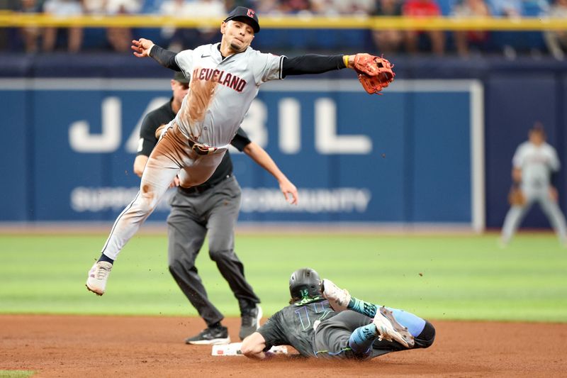 Jul 13, 2024; St. Petersburg, Florida, USA; Tampa Bay Rays designated hitter Josh Lowe (15) steals second base under Cleveland Guardians second baseman Andres Gimenez (0) in the third inning at Tropicana Field. Mandatory Credit: Nathan Ray Seebeck-USA TODAY Sports