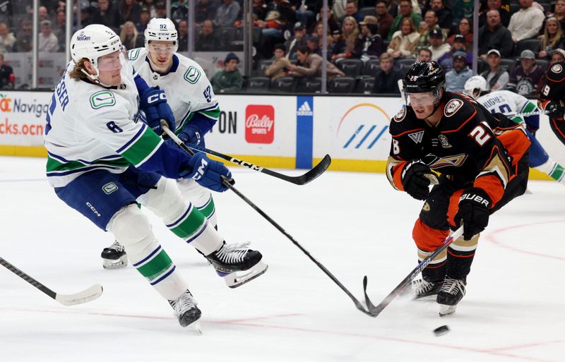 Mar 3, 2024; Anaheim, California, USA; Vancouver Canucks right wing Brock Boeser (6) shoots against Anaheim Ducks defenseman Gustav Lindstrom (28) during the first period at Honda Center. Mandatory Credit: Jason Parkhurst-USA TODAY Sports