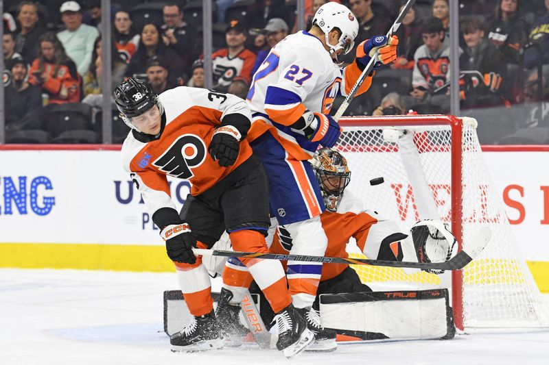 Sep 26, 2024; Philadelphia, Pennsylvania, USA; New York Islanders left wing Anders Lee (27) battles with Philadelphia Flyers defenseman Emil Andrae (36) in front of goaltender Samuel Ersson (33) during the first period at Wells Fargo Center. Mandatory Credit: Eric Hartline-Imagn Images