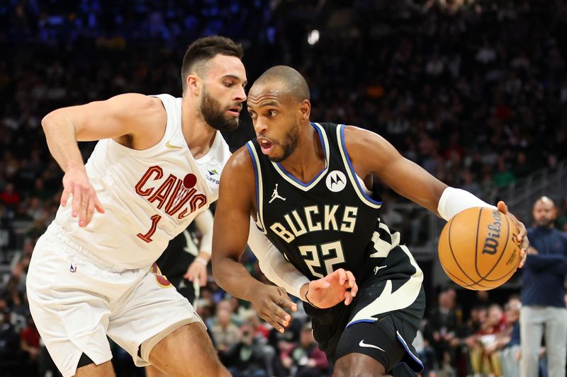 MILWAUKEE, WISCONSIN - JANUARY 26: Khris Middleton #22 of the Milwaukee Bucks drives around Max Strus #1 of the Cleveland Cavaliers during the first half of a game at Fiserv Forum on January 26, 2024 in Milwaukee, Wisconsin. NOTE TO USER: User expressly acknowledges and agrees that, by downloading and or using this photograph, User is consenting to the terms and conditions of the Getty Images License Agreement. (Photo by Stacy Revere/Getty Images)