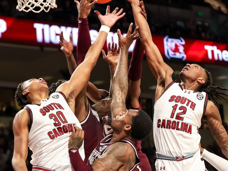 Jan 6, 2024; Columbia, South Carolina, USA; South Carolina Gamecocks forward Collin Murray-Boyles (30), guard Zachary Davis (12), Mississippi State Bulldogs forward Jimmy Bell Jr. (15) and others battle for a rebound in the second half at Colonial Life Arena. Mandatory Credit: Jeff Blake-USA TODAY Sports