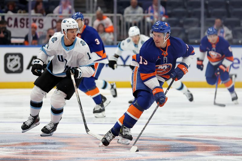 Oct 10, 2024; Elmont, New York, USA; New York Islanders center Mathew Barzal (13) skates with the puck against Utah Hockey Club right wing Dylan Guenther (11) during the second period at UBS Arena. Mandatory Credit: Brad Penner-Imagn Images