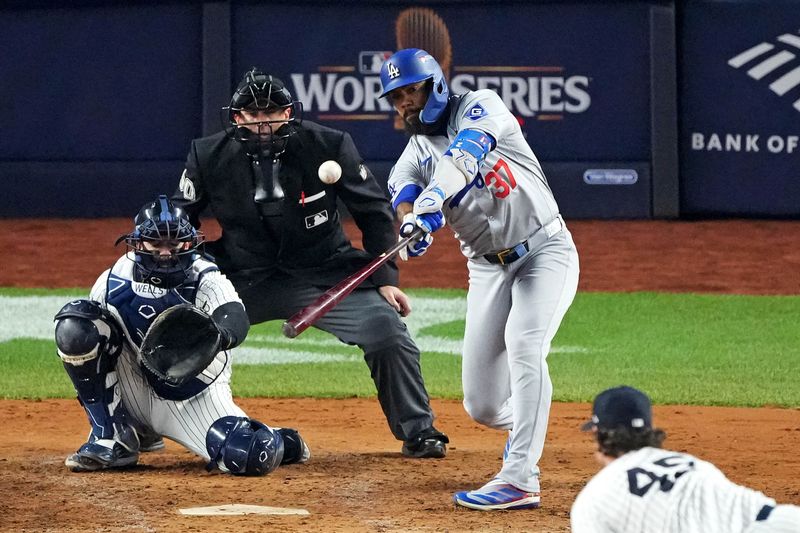 Oct 30, 2024; New York, New York, USA; Los Angeles Dodgers outfielder Teoscar Hernandez (37) hits a two RBI double during the fifth inning against the New York Yankees in game four of the 2024 MLB World Series at Yankee Stadium. Mandatory Credit: Robert Deutsch-Imagn Images