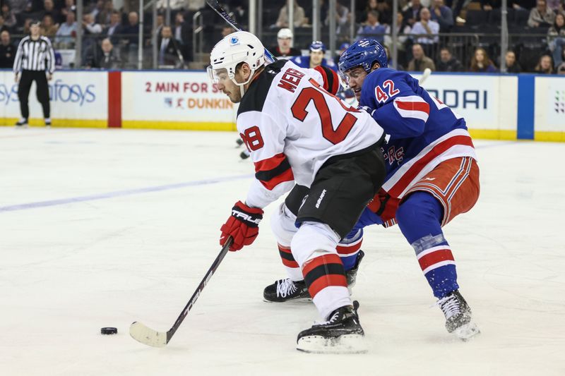 Mar 18, 2026; New York, New York, USA;  New Jersey Devils right wing Timo Meier (28) and New York Rangers center Noah Laba (42) battle for control of the puck in the second period at Madison Square Garden. Mandatory Credit: Wendell Cruz-Imagn Images