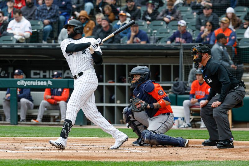 May 4, 2025; Chicago, Illinois, USA; Chicago White Sox center fielder Luis Robert Jr. (88) singles against the Houston Astros during the first inning at Rate Field. Mandatory Credit: Kamil Krzaczynski-Imagn Images