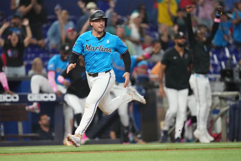 May 12, 2024; Miami, Florida, USA;  Miami Marlins catcher Nick Fortes (4) scores the winning run in the tenth inning against the Philadelphia Phillies at loanDepot Park. Mandatory Credit: Jim Rassol-USA TODAY Sports