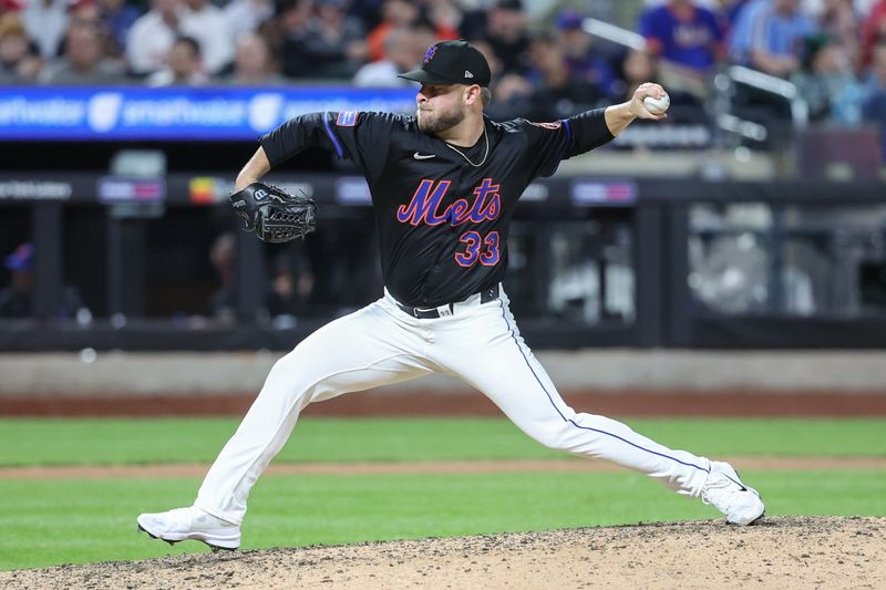 Apr 22, 2025; New York City, New York, USA;  New York Mets relief pitcher A.J. Minter (33) pitches in the sixth inning against the Philadelphia Phillies at Citi Field. Mandatory Credit: Wendell Cruz-Imagn Images
