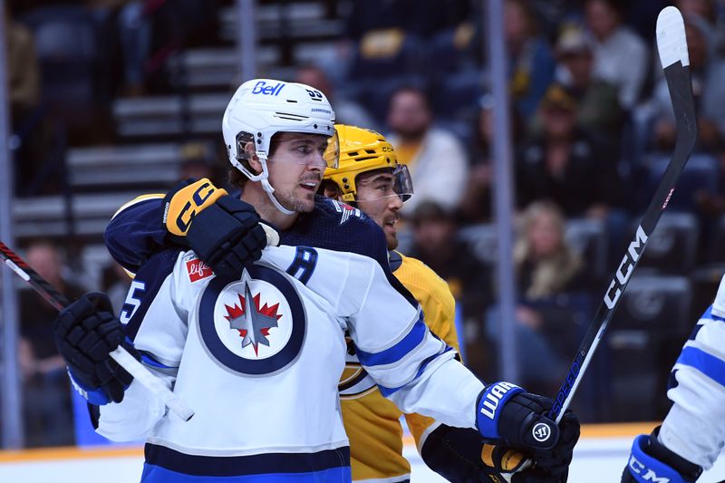 Apr 9, 2024; Nashville, Tennessee, USA; Nashville Predators left wing Kiefer Sherwood (44) holds Winnipeg Jets center Mark Scheifele (55) as players gather in front of the net after the whistle during the first period at Bridgestone Arena. Mandatory Credit: Christopher Hanewinckel-USA TODAY Sports