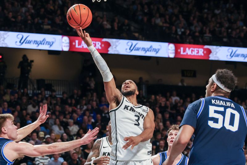 Jan 13, 2024; Orlando, Florida, USA; UCF Knights guard Darius Johnson (3) attempts a shot during the second half against the Brigham Young Cougars at Addition Financial Arena. Mandatory Credit: Mike Watters-USA TODAY Sports