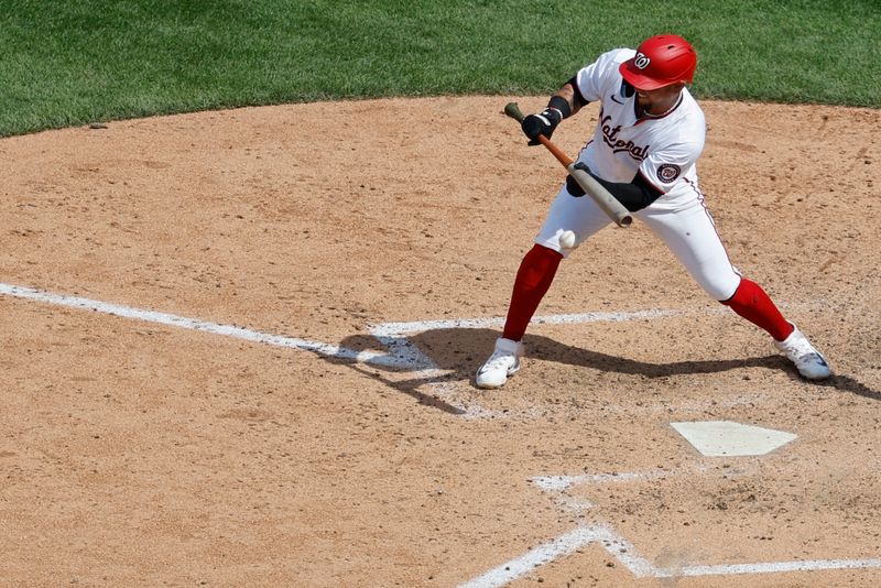 May 22, 2024; Washington, District of Columbia, USA; Washington Nationals second base Ildemaro Vargas (14) hits a sacrifice bunt against the Minnesota Twins during the ninth inning at Nationals Park. Mandatory Credit: Geoff Burke-USA TODAY Sports