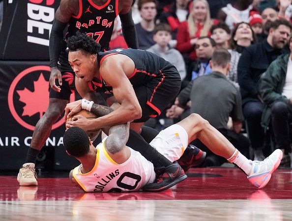 TORONTO, ON - DECEMBER 23: Scottie Barnes #4 of the Toronto Raptors battles for the ball with John Collins #20 of the Utah Jazz during the first half of their basketball game at the Scotiabank Arena on December 23, 2023 in Toronto, Ontario, Canada. NOTE TO USER: User expressly acknowledges and agrees that, by downloading and/or using this Photograph, user is consenting to the terms and conditions of the Getty Images License Agreement. (Photo by Mark Blinch/Getty Images)