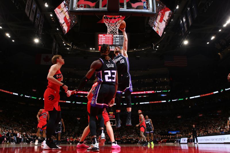 TORONTO, CANADA - MARCH 20: Domantas Sabonis #10 of the Sacramento Kings dunks the ball during the game against the Toronto Raptors on March 20, 2024 at the Scotiabank Arena in Toronto, Ontario, Canada.  NOTE TO USER: User expressly acknowledges and agrees that, by downloading and or using this Photograph, user is consenting to the terms and conditions of the Getty Images License Agreement.  Mandatory Copyright Notice: Copyright 2024 NBAE (Photo by Vaughn Ridley/NBAE via Getty Images)