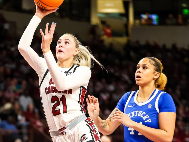 Jan 15, 2024; Columbia, South Carolina, USA; South Carolina Gamecocks forward Chloe Kitts (21) drives past Kentucky Wildcats forward Janae Walker (44) in the first half at Colonial Life Arena. Mandatory Credit: Jeff Blake-USA TODAY Sports