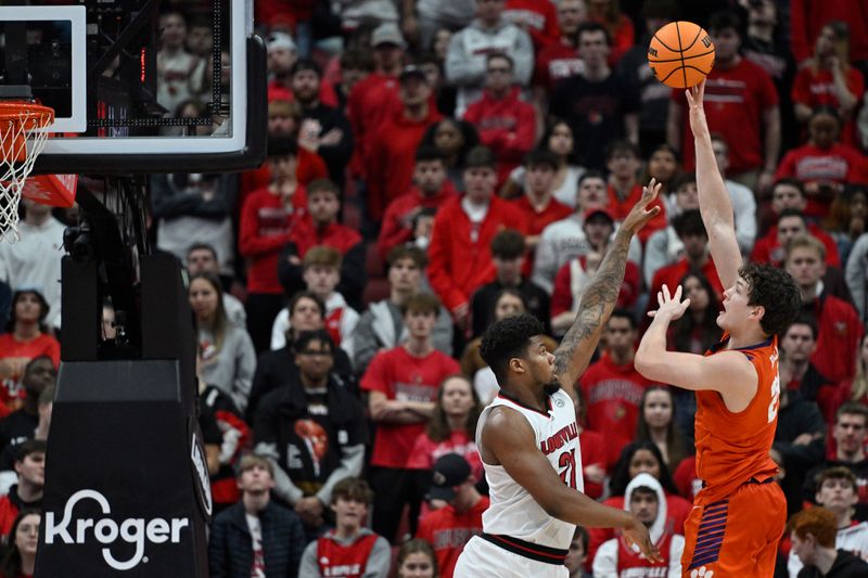 Feb 18, 2023; Louisville, Kentucky, USA;  Clemson Tigers center PJ Hall (24) shoots against Louisville Cardinals forward Sydney Curry (21) during the second half at KFC Yum! Center. Louisville defeated Clemson 83-73. Mandatory Credit: Jamie Rhodes-USA TODAY Sports