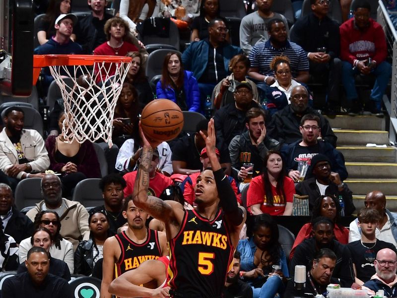 ATLANTA, GA - February 23:   Dejounte Murray #5 of the Atlanta Hawks drives to the basket during the game against the Toronto Raptors on February 23, 2024 at State Farm Arena in Atlanta, Georgia.  NOTE TO USER: User expressly acknowledges and agrees that, by downloading and/or using this Photograph, user is consenting to the terms and conditions of the Getty Images License Agreement. Mandatory Copyright Notice: Copyright 2024 NBAE (Photo by Scott Cunningham/NBAE via Getty Images)