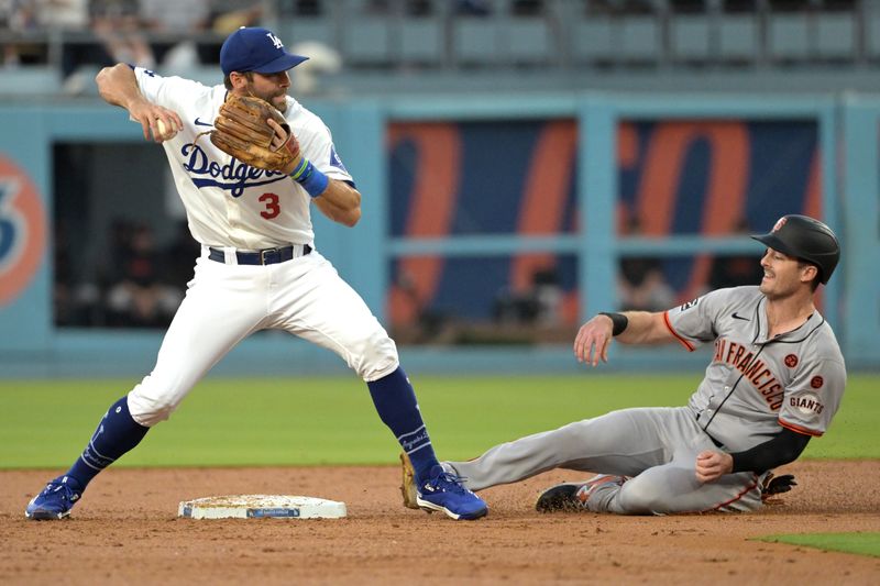 Jul 24, 2024; Los Angeles, California, USA;  Los Angeles Dodgers left fielder Chris Taylor (3) throws to first as San Francisco Giants right fielder Mike Yastrzemski (5) is out on a double play in the second inning at Dodger Stadium. Mandatory Credit: Jayne Kamin-Oncea-USA TODAY Sports