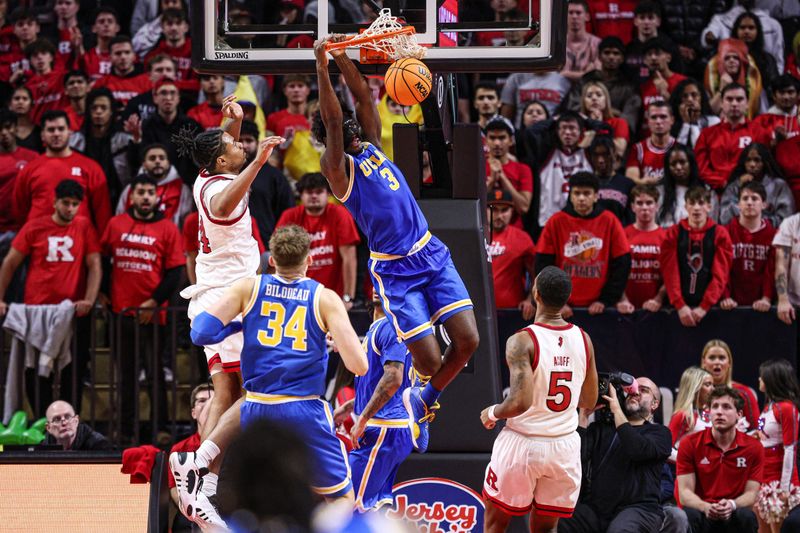 Jan 13, 2025; Piscataway, New Jersey, USA; UCLA Bruins guard Eric Dailey Jr. (3) dunks the ball in front of Rutgers Scarlet Knights center Lathan Sommerville (24) during the second half at Jersey Mike's Arena. Mandatory Credit: Vincent Carchietta-Imagn Images