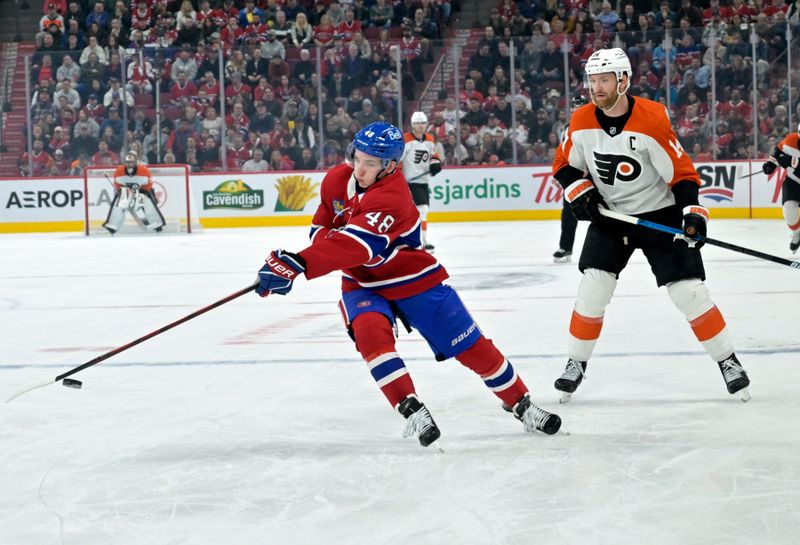 Apr 5, 2025; Montreal, Quebec, CAN; Montreal Canadiens defenseman Lane Hutson (48) intercepts the puck in front of Philadelphia Flyers forward Sean Couturier (14) during the third period at the Bell Centre. Mandatory Credit: Eric Bolte-Imagn Images