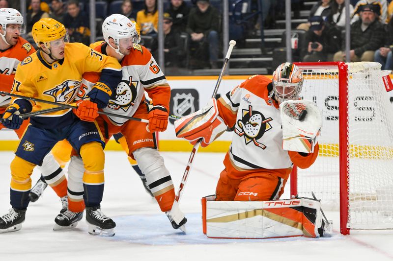 Mar 20, 2025; Nashville, Tennessee, USA;  Anaheim Ducks goaltender John Gibson (36) makes a glove save against the Nashville Predators during the third period at Bridgestone Arena. Mandatory Credit: Steve Roberts-Imagn Images