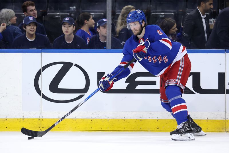 May 22, 2024; New York, New York, USA; New York Rangers defenseman Jacob Trouba (8) controls the puck against the Florida Panthers during the third period of game one of the Eastern Conference Final of the 2024 Stanley Cup Playoffs at Madison Square Garden. Mandatory Credit: Brad Penner-USA TODAY Sports