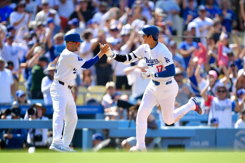 Jul 25, 2024; Los Angeles, California, USA; Los Angeles Dodgers designated hitter Shohei Ohtani (17) is greeted by third base coach Dino Ebel (91) after hitting a solo home run against the San Francisco Giants during the eighth inning at Dodger Stadium. Mandatory Credit: Gary A. Vasquez-USA TODAY Sports