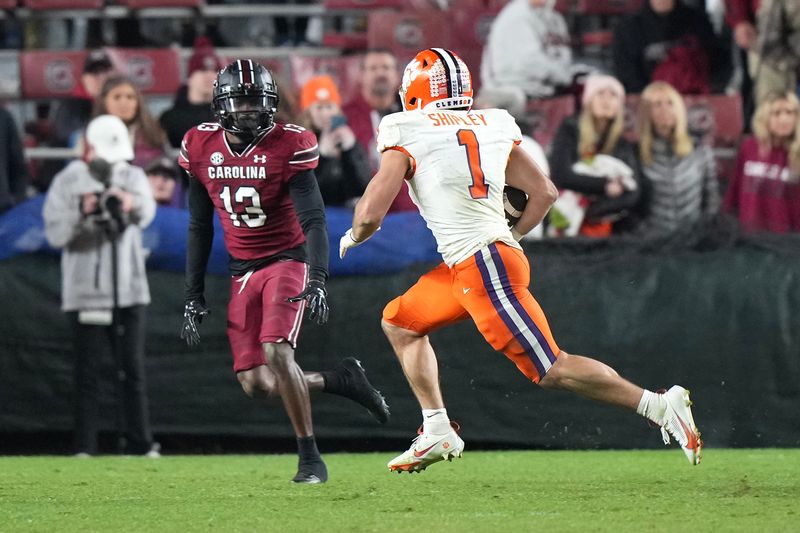 Nov 25, 2023; Columbia, South Carolina, USA; Clemson Tigers running back Will Shipley (1) runs the ball against South Carolina Gamecocks defensive back Kajuan Banks (13) in the second half at Williams-Brice Stadium. Mandatory Credit: David Yeazell-USA TODAY Sports