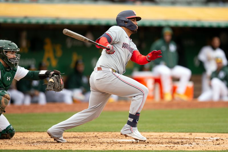 Apr 13, 2024; Oakland, California, USA; Washington Nationals second baseman Luis García Jr. (2) follows through on his single against the Oakland Athletics during the fourth inning at Oakland-Alameda County Coliseum. Mandatory Credit: D. Ross Cameron-USA TODAY Sports