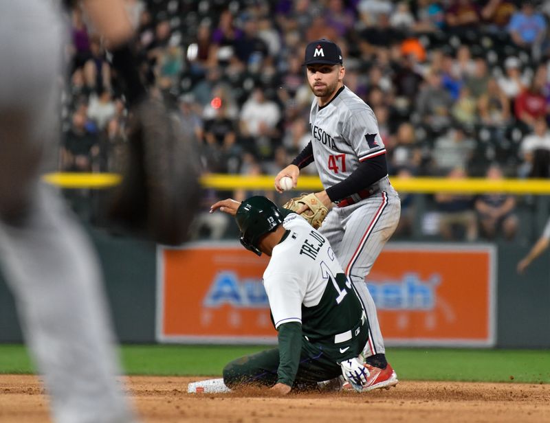 Sep 30, 2023; Denver, Colorado, USA;  Colorado Rockies third baseman Alan Trejo (13) breaks up the double play attempt as Minnesota Twins second baseman Edouard Julien (47) holds off on the throw in the third inning at Coors Field. Mandatory Credit: John Leyba-USA TODAY Sports