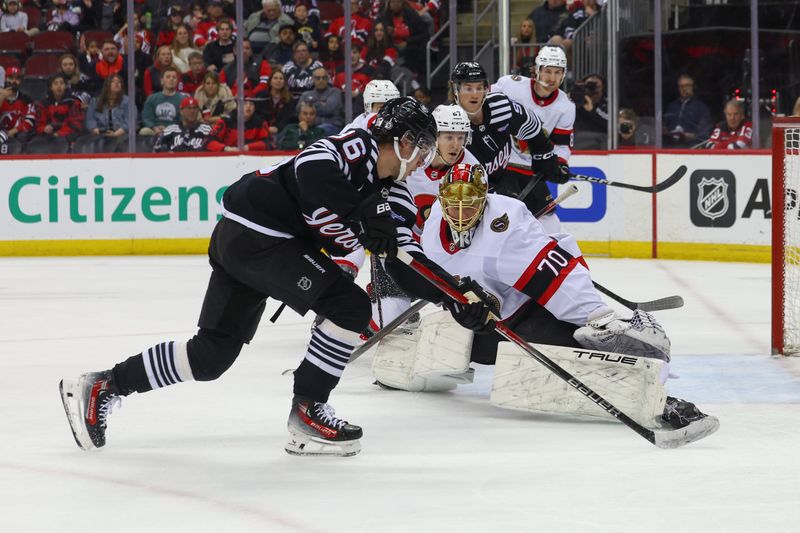 Mar 23, 2024; Newark, New Jersey, USA; New Jersey Devils center Jack Hughes (86) skates with the puck while Ottawa Senators goaltender Joonas Korpisalo (70) defends his net during the second period at Prudential Center. Mandatory Credit: Ed Mulholland-USA TODAY Sports