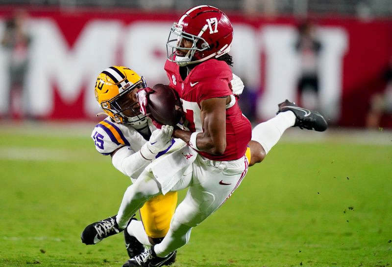 Nov 4, 2023; Tuscaloosa, Alabama, USA; Alabama Crimson Tide wide receiver Isaiah Bond (17) hauls in a pass against LSU Tigers safety Sage Ryan (15) during the second half at Bryant-Denny Stadium. Alabama Crimson Tide defeated the LSU Tigers 42-28. Mandatory Credit: John David Mercer-USA TODAY Sports